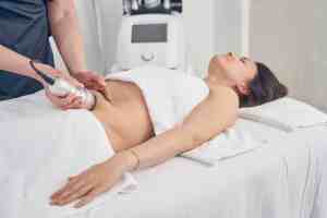 Woman receiving body contouring treatment