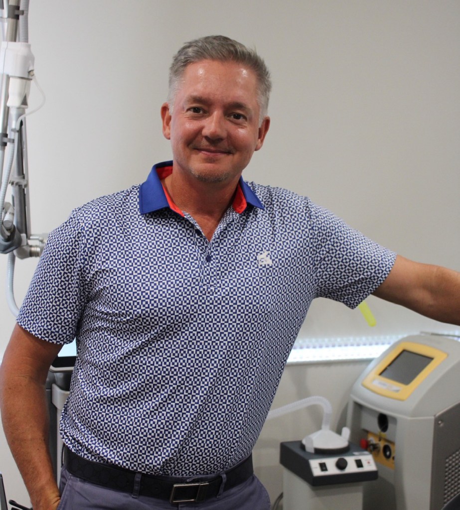 A Wyndhurst provider beside the fractional CO2 laser system used for skin resurfacing